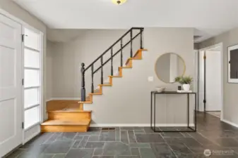 Foyer with storage under the stairs.