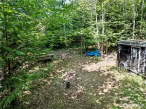 Picnic table, firepit, tent spot, and the start of a treehouse. This is building area #1 where the septic design was done in 2020.