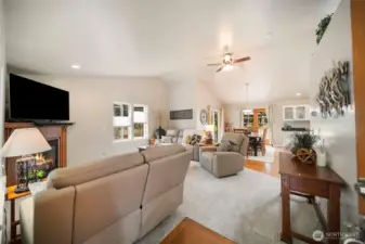 Upon entering, you are welcomed by soaring ceilings and an inviting living room with a propane fireplace.