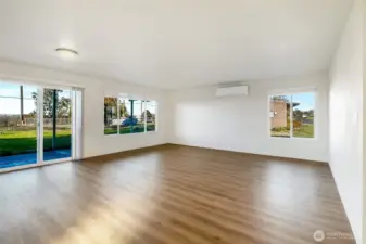 New flooring and new windows! Living room with sliding doors to the back patio.