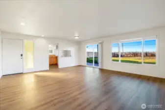 Living room and dining area have all new flooring throughout. Sliding glass doors to the back yard.
