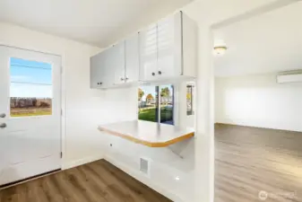 The back door in the kitchen leads out to the covered back patio.  You'll enjoy new flooring in the kitchen and living room.