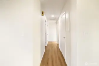Hallway with new flooring down to the bedrooms.