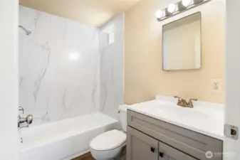 Remodeled bathroom with new tub, vanity, and tub surround.