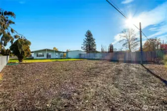 Low maintenance bark area is a perfect area to put a playset, fort, or raised garden beds.
