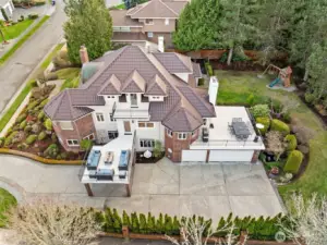 home showcases elegant architecture complemented by multiple decks overlooking a beautifully landscaped yard