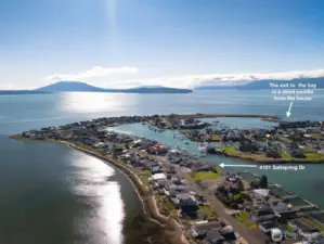 Uniquely situated on a spectacular spit with beautiful water views and easy access to the bay