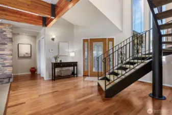 The dramatic entry and beautiful iron staircase set the tone for this unique home