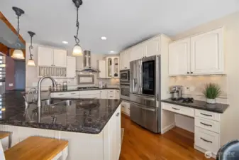 There is a tremendous amount of storage & countertop space in this beautifully appointed kitchen that features a new gas cooktop and stylish fridge with a "window"! And there are hidden outlets for all your gadgets!
