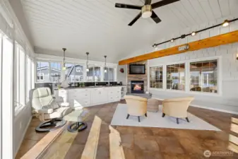 This room has so much space that it can accommodate areas for relaxing AND dining AND even a puzzle table as well!