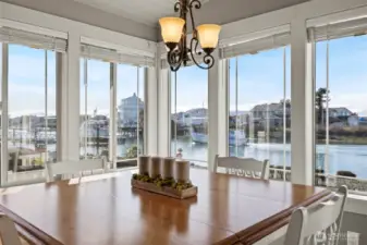Dining area in the sunroom; there is sliding door to an additional paved patio on the side that is perfect grilling space