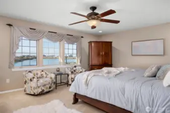 The main floor primary suite with a lovely water view (and there is another upstairs!)