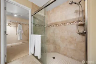 A zero entry shower and a massive walk in closet
