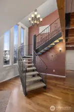 The wrought iron staircase is a work of art and overlooks the front patio courtyard