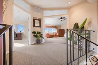 A spacious landing with the second primary bedroom suite to the right and the 4th bedroom (currently used as an office) to the left