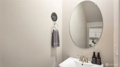 Main level powder room with pedestal sink and modern fixtures.