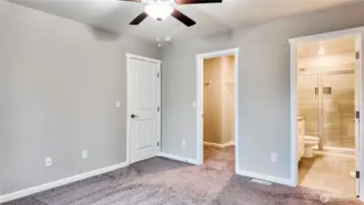 Spacious primary bedroom with ensuite bath and walk in closet.