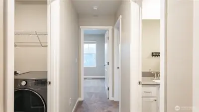 Upper level hallway with access to full bath and laundry area.