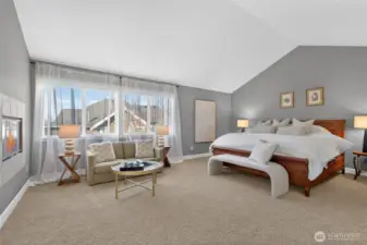 Oversized primary suite with cathedral ceilings.