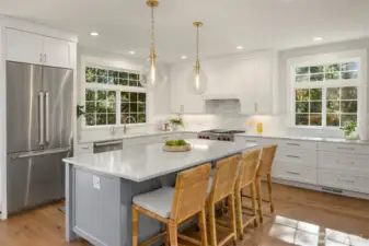 Custom Shaker cabinetry and garden view windows.