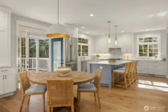 Kitchen dining tied in with indoor/outdoor with Regina Andrew Pendant