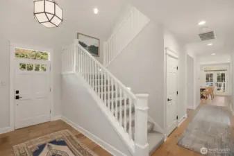 Two story foyer with a Morris Pendant by Visual Comfort.