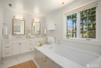 Kohler soaking tub, heated floors, double sink vanity.