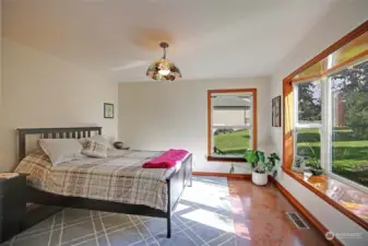 Guest bedroom on main level with cork flooring & lovely window seat.