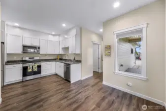 The halway leads to he bathroom, w/d and garage.  There is a large deck outside the window.
