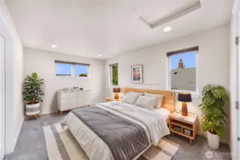 At the top of the stairs is the primary suite, virtually staged.
