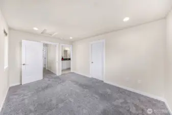 Primary suite, entrance on the left, en suite middle door and walk in closet on the right