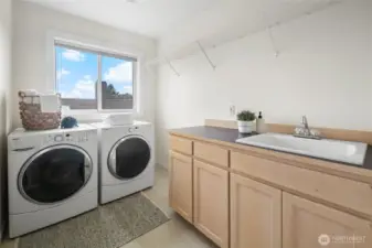 Second floor laundry room and utility sink. Option to air dry on clothes line on the upstairs deck.