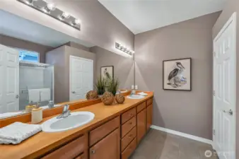 The primary bath has a double sink vanity with lots of storage, a step-in shower and a private water closet.