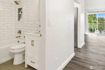 Bathroom with view of kitchen and living room