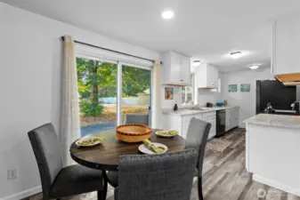 Updated and light-filled Kitchen eating nook with slider access to the deck for easy indoor–outdoor living