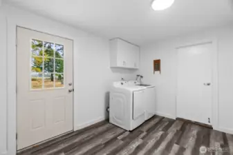 Generous laundry/mudroom, ideally situated between the garage and kitchen, with private outdoor access for added convenience