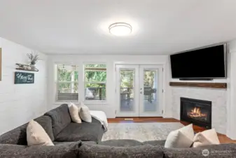 Main level living room opens to fully covered back deck.