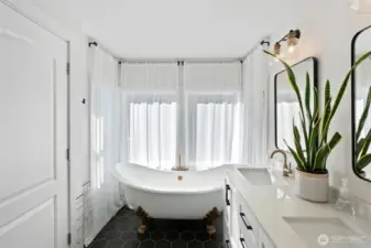 Primary bedroom ensuite with clawfoot bathtub.