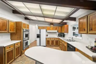 Open kitchen with eating bar.