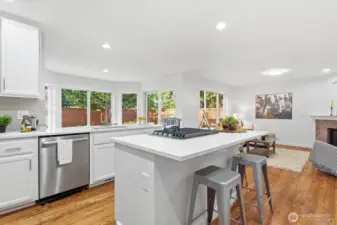 Spacious island with brand-new gas cooktop and convenient eat-in bar.