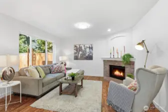Family room featuring a gas fireplace with charming brick surround.