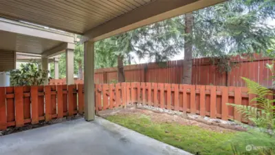Just off the garage you will find this fenced in small grassy space and covered patio allowing you to enjoy the outdoors year round.
