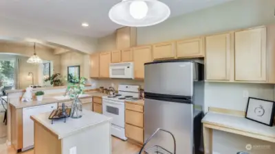 Enjoy tons of cabinet & counter space plus an island in this kitchen with open sight lines all the way to the living room.