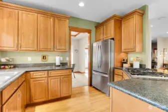 Chef's kitchen with storage/cabinets galore!  Stainless appliances, wall oven, gas cook top, hardwood floors, eating area and granite counter tops.