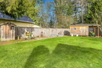 2 raised garden beds, potting shed and large shed with covered toy, rider and wood storage.