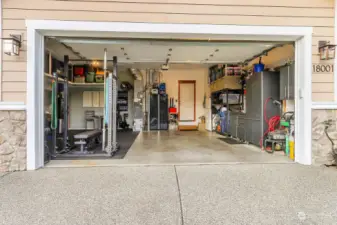 Double garage with extra work space, overhead storage, heater and EV charger.