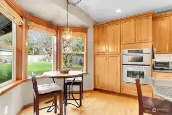 Chef's kitchen with storage/cabinets galore!  Stainless appliances, wall oven, gas cook top, hardwood floors, eating area and granite counter tops.