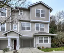 Set back from the street, surrounded by mature trees, offering a warm welcome home, complete with an oversized garage and parking in front of garage.