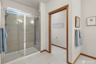 Primary bathroom with 2 sinks, walk in shower and a toilet closet. Tile floors.