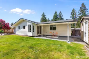 View of back of home with garden beds
